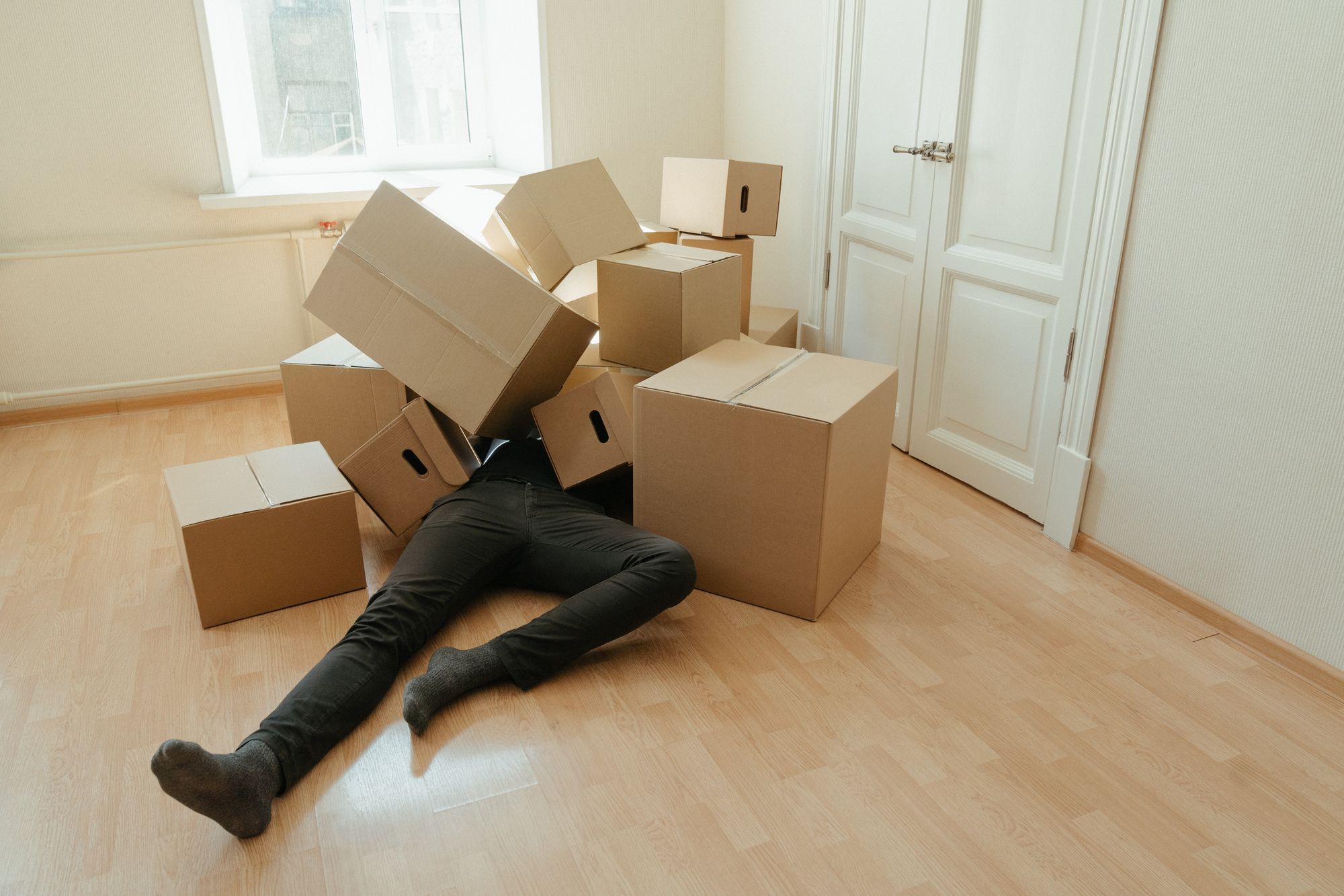 A man half-buried under moving boxes