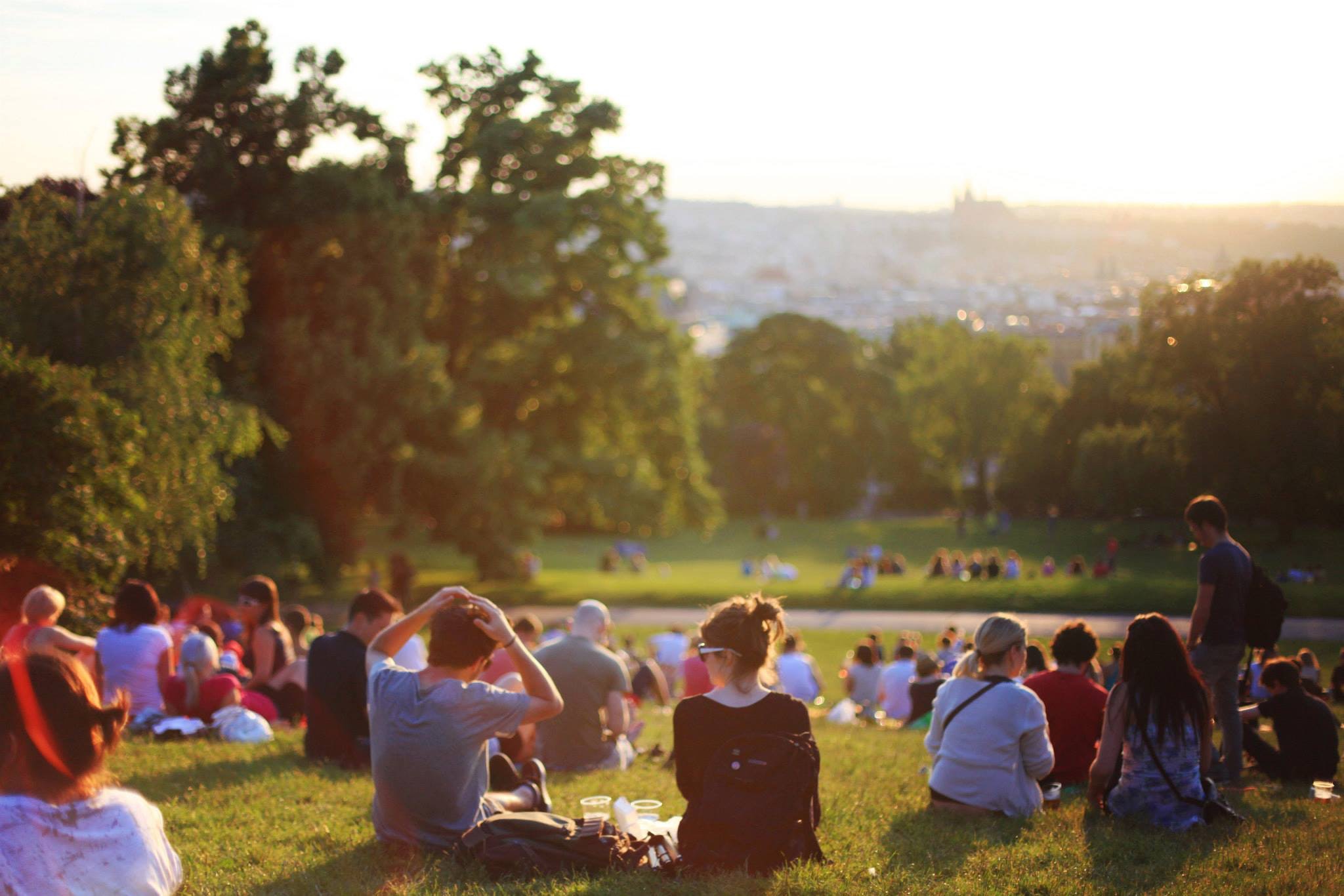 A group of people sitting in a park