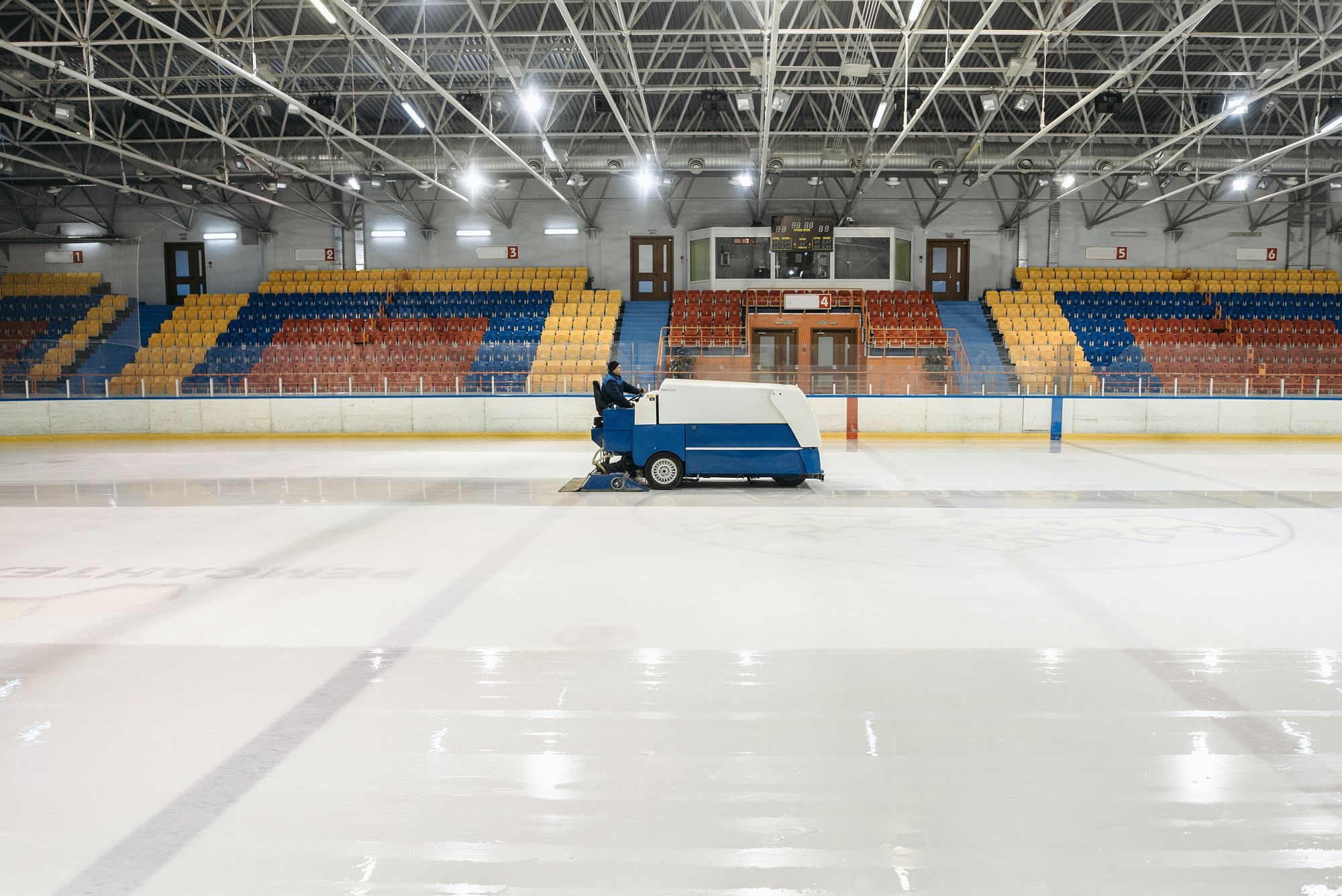A Zamboni cleaning the ice in a rink