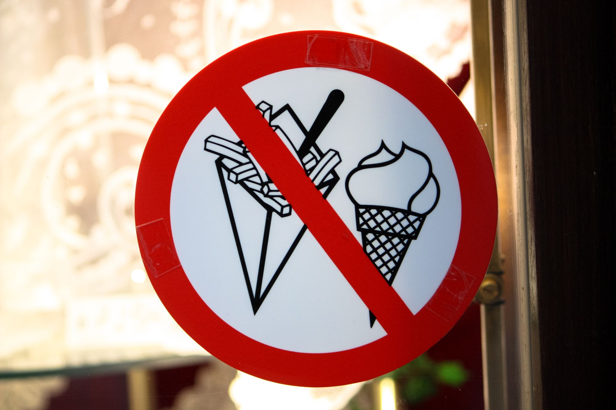 A red "banned" sign with ice cream and French fries