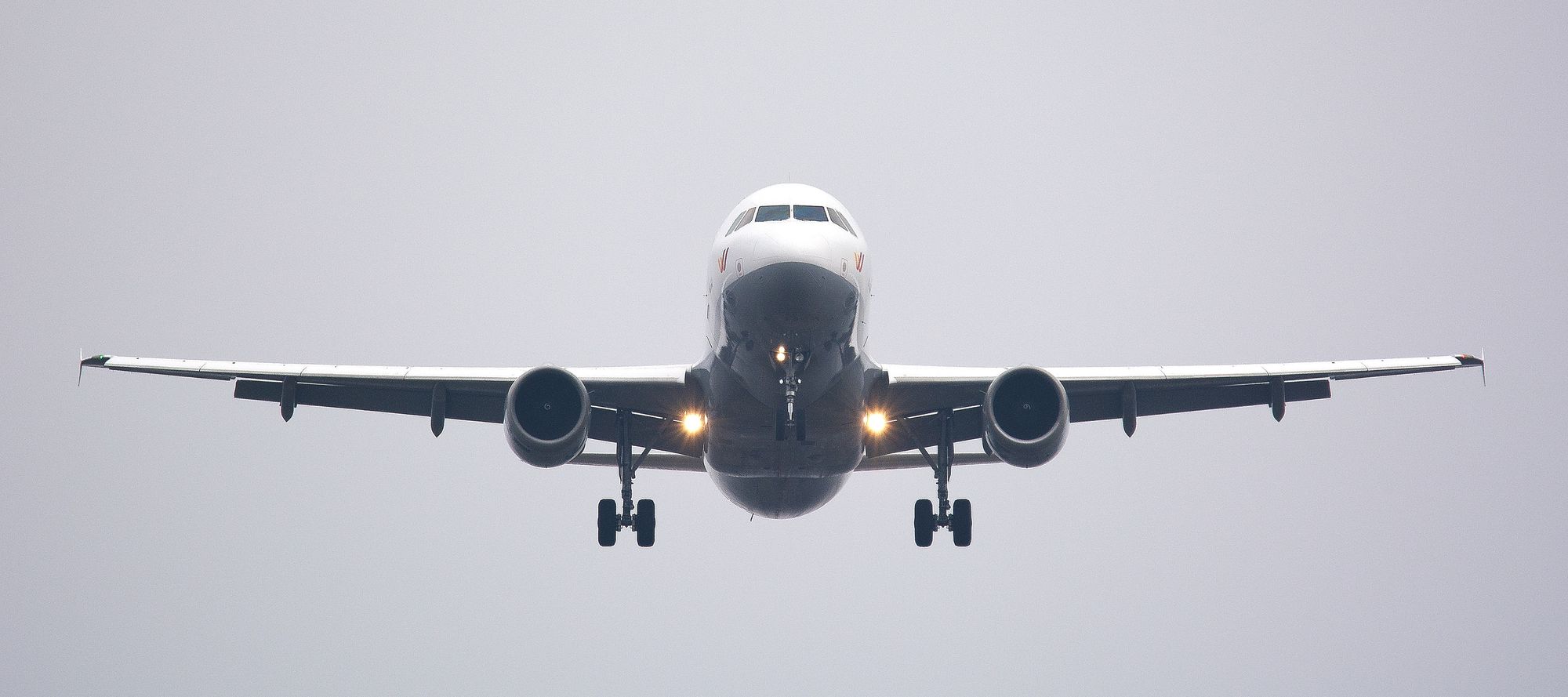 A commercial airplane flying directly towards the camera.