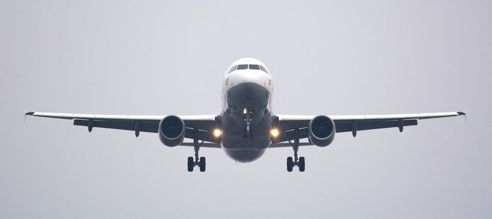 A commercial airplane flying directly towards the camera.